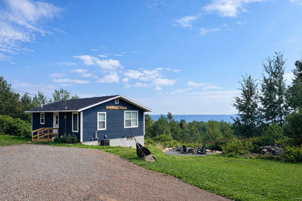 White Rock is a charming, newly refreshed home set at the very end of the road with peaceful Lake Superior views in the background. The cozy yard and quiet setting make it perfect for relaxing, unplugging, and enjoying a true North Shore getaway.