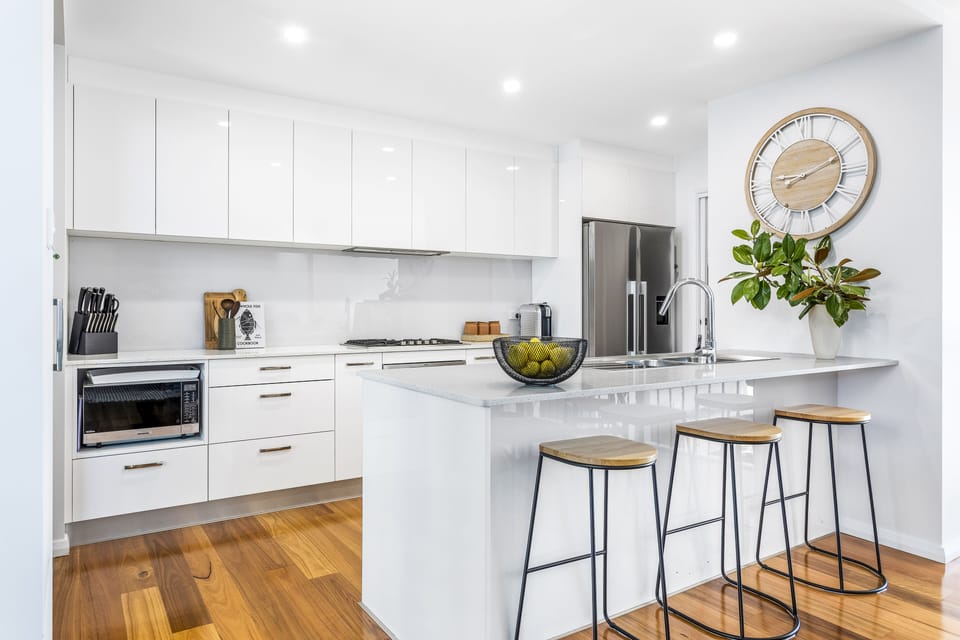 Modern kitchen.  Gas cooktop, oven, microwave, fridge, dishwasher, coffee, tea