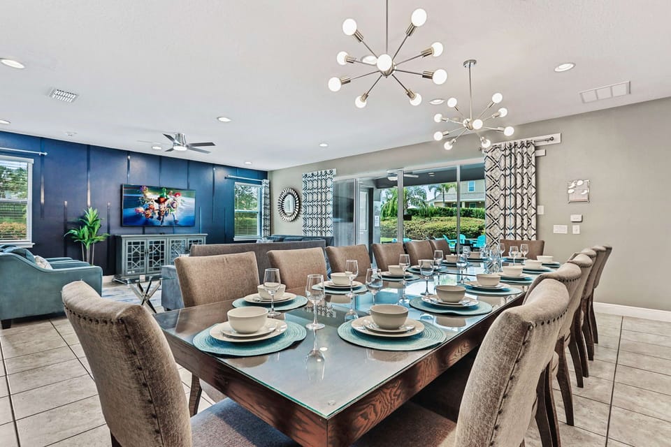 The formal dining space seats a large group, ideal for family meals, celebrations, or even catered dinners.