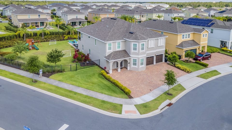 This bright and inviting façade welcomes guests to a luxurious retreat in a peaceful, upscale community.