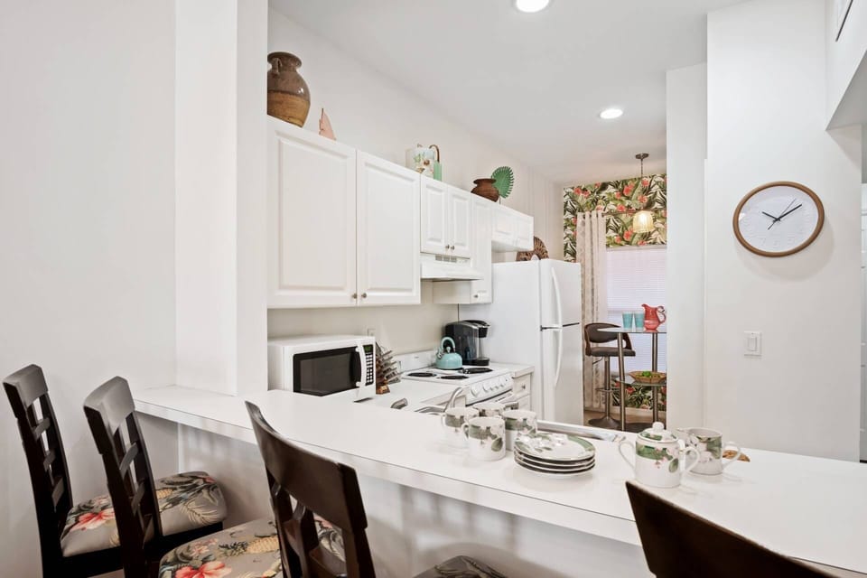 The kitchen with breakfast bar seating is fully stocked with all the comforts of home.