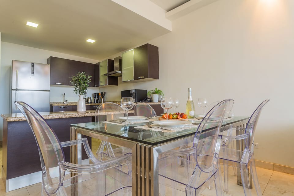 Eclat Dining Area of the lovely condo in Oranjestad Aruba - 6 Persons Dining - Functional and aesthetically pleasing storage solutions for tableware - Open layout seamlessly connecting the dining area to the kitchen and living room.