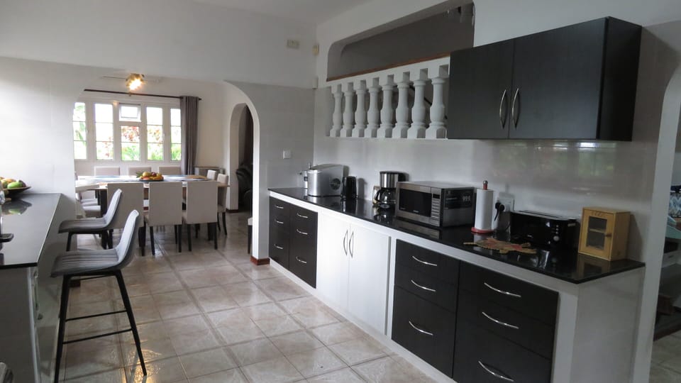 Kitchen with Breakfast bar and dining area beyond