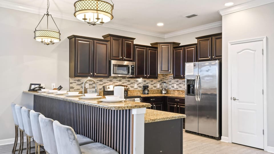 Compact kitchen, featuring a charming mini breakfast bar for cozy morning gatherings
