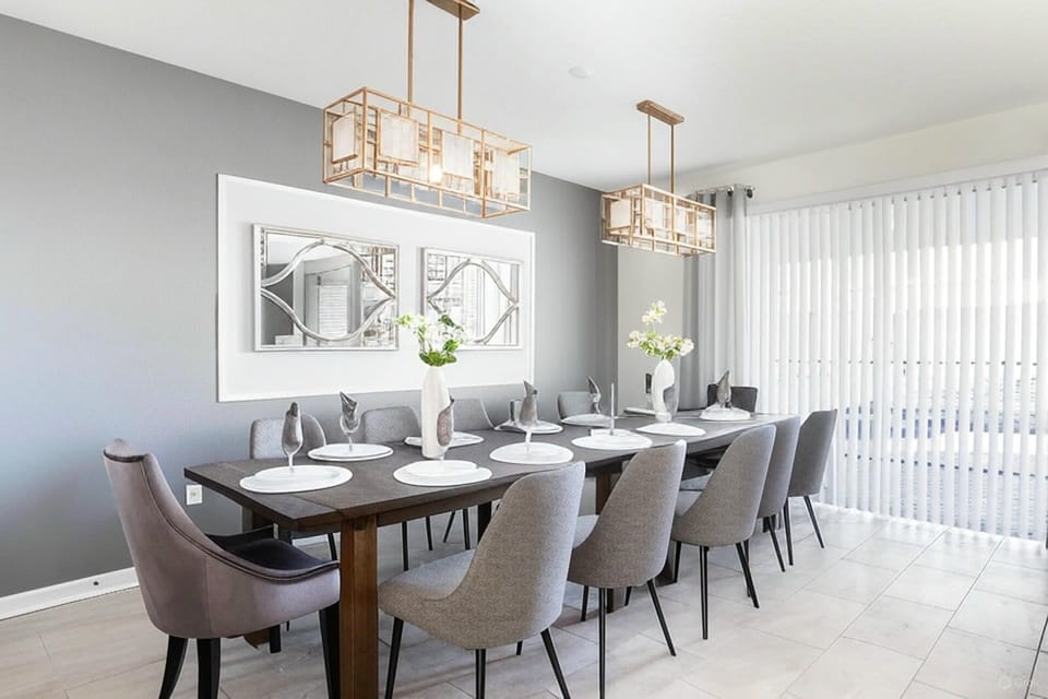 Elegant dining room with seating for 12, modern lighting, and stylish decor.
