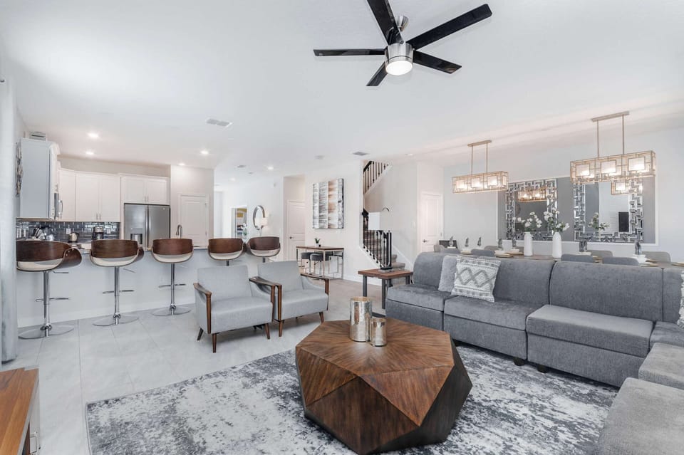 Spacious open-concept living area with modern decor, sleek kitchen, and dining.