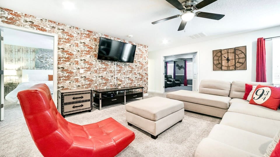 Cozy loft lounge with brick accent wall, smart TV, and themed Harry Potter decor