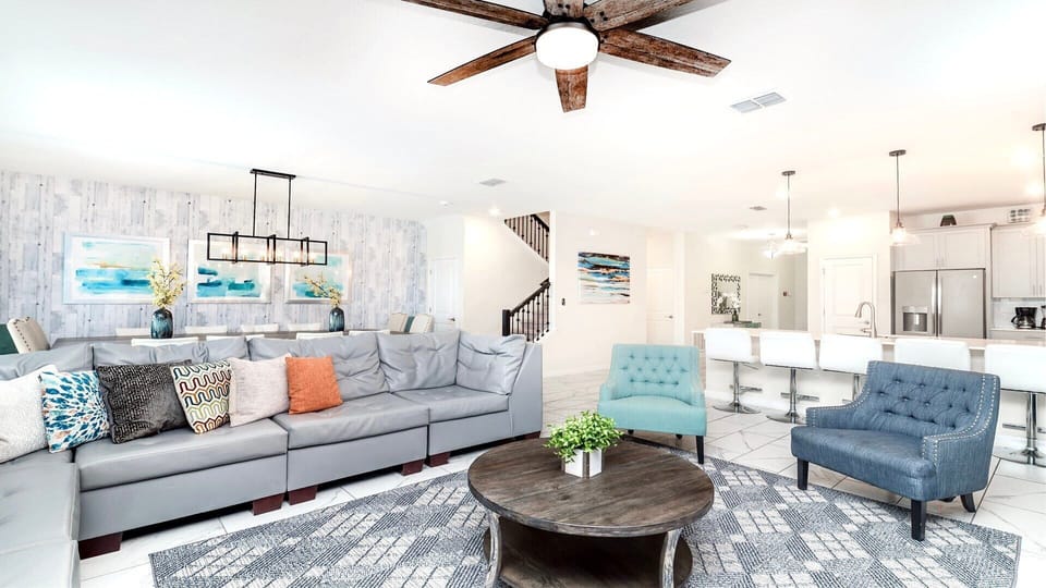 Spacious open-concept living with designer seating, modern kitchen, and style