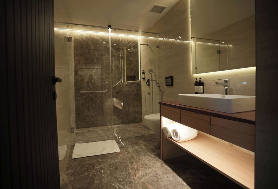 Premium Suite, 1 King Bed, Non Smoking (Separate Living Room;with Sofabed) | Bathroom | Shower, hair dryer, slippers, towels