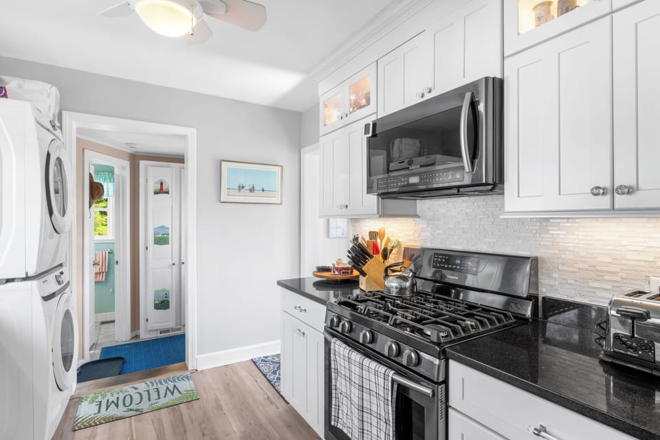 Renovated kitchen looking to back entrance and downstairs bathroom