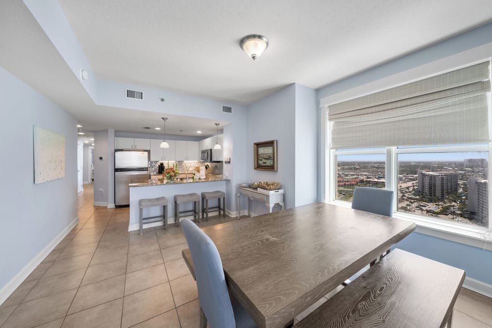 Your spacious open-concept living blends kitchen and dining seamlessly, while floor-to-ceiling windows frame stunning city views for every meal.