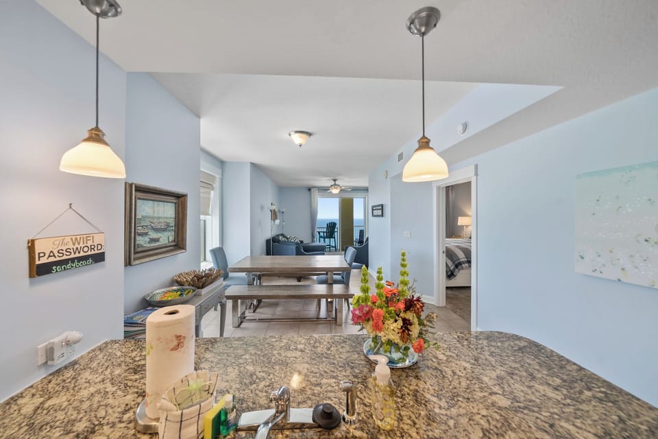 Your open kitchen flows seamlessly into the dining area, where warm pendant lights create an inviting atmosphere for memorable meals together.