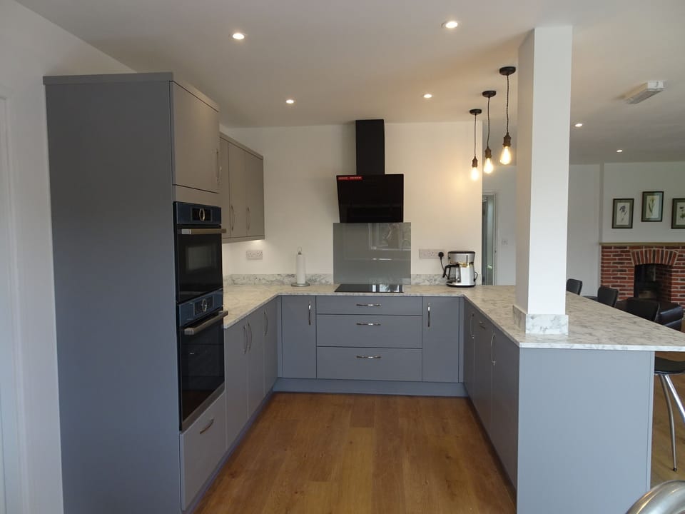 Kitchen with double ovens, microwave, washing machine, fridge freezer