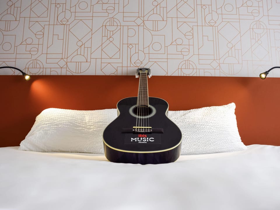 Premium bedding, desk, laptop workspace, blackout drapes