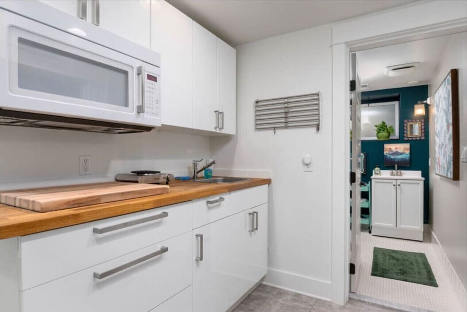 Side view of the kitchenette and entrance to one of two bathrooms.