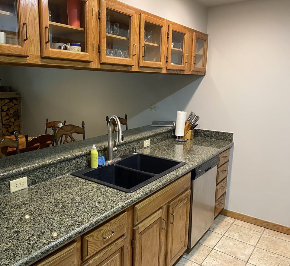 Kitchen opens up to living room with bar seating. 