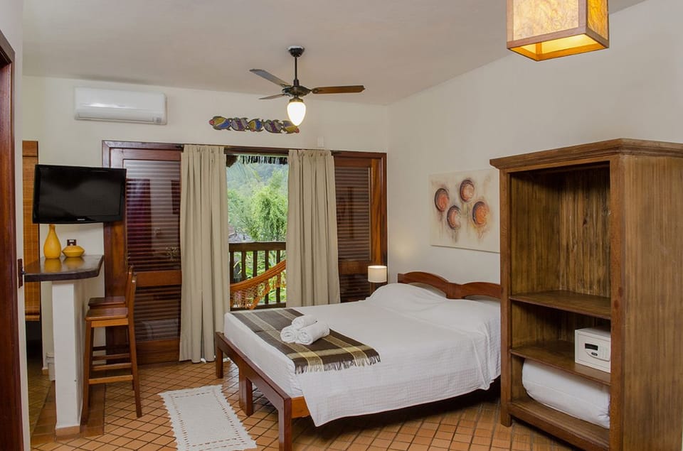 Standard Apartment | Minibar, in-room safe, individually decorated, iron/ironing board