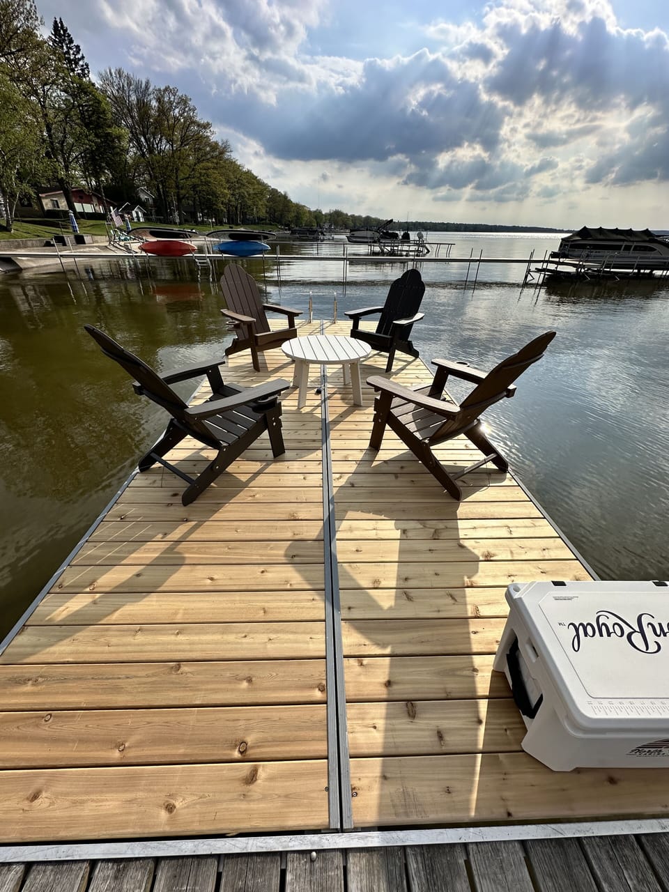 Enjoy the sunshine on your own deck and steps to the sandy bottom lake!