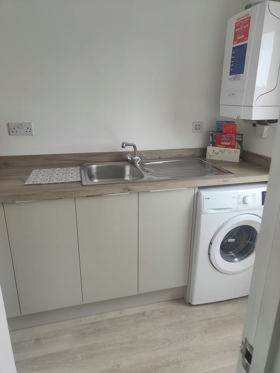 utility room with washing machine, access to garden 