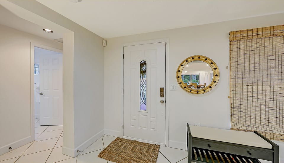 Main entrance foyer just inside the home.  To the left is the front bedroom #2.  To right, the kitchen and main living area.