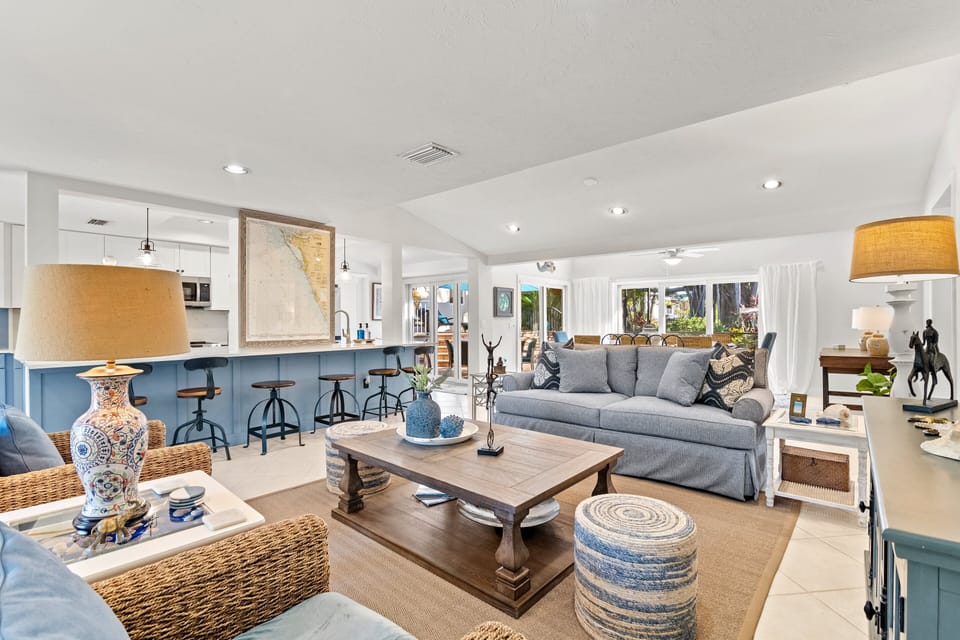 View from inside the front door with the living room, kitchen dining room and door to the patio area in background.