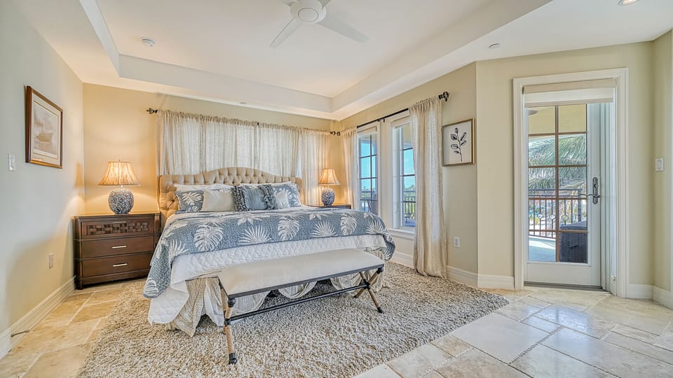 Wake up to soft light and the promise of sea air—this spacious king suite opens directly to a private balcony, blending indoor comfort with breezy coastal living.