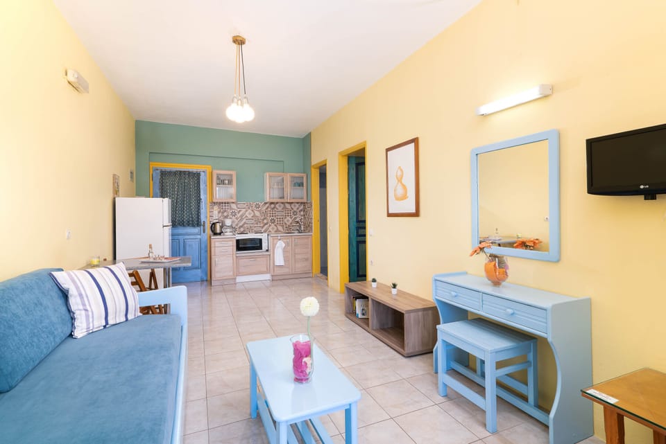 Apartment, Sea View | Living area | 22-inch flat-screen TV with cable channels, TV