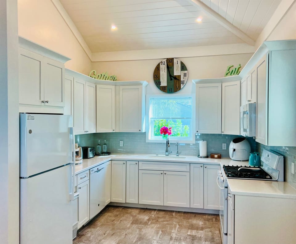 Kitchen includes Full size refrigerator/freezer, self standing ice maker, 4 burner and griddle gas range with gas oven, dishwasher, large sink with garbage disposal and microwave.