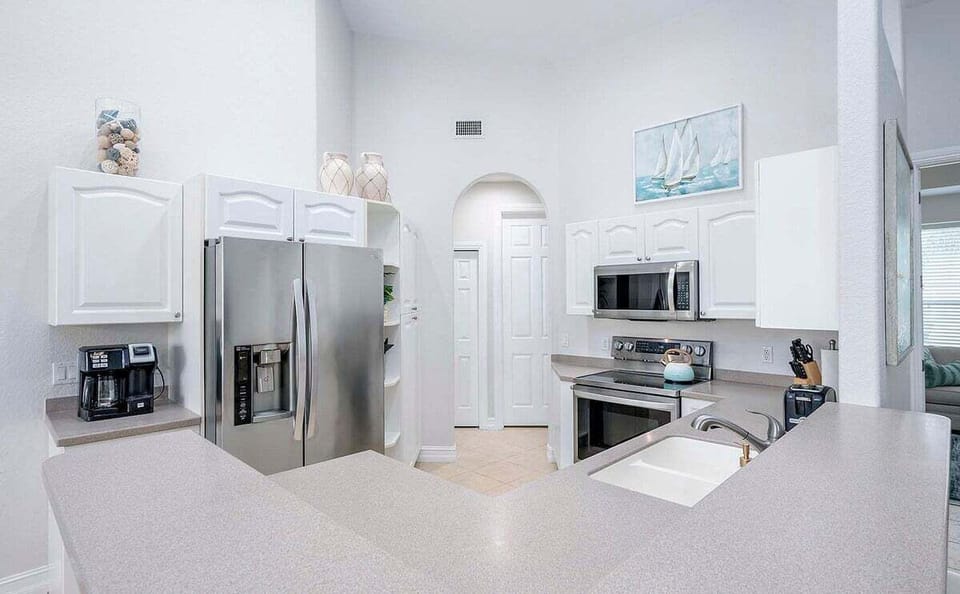 Open Kitchen with Stainless Appliances and Bar