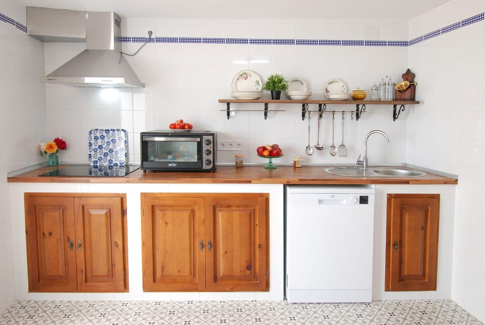 The kitchen is comfortable and original with views at terrace and swimming pool.