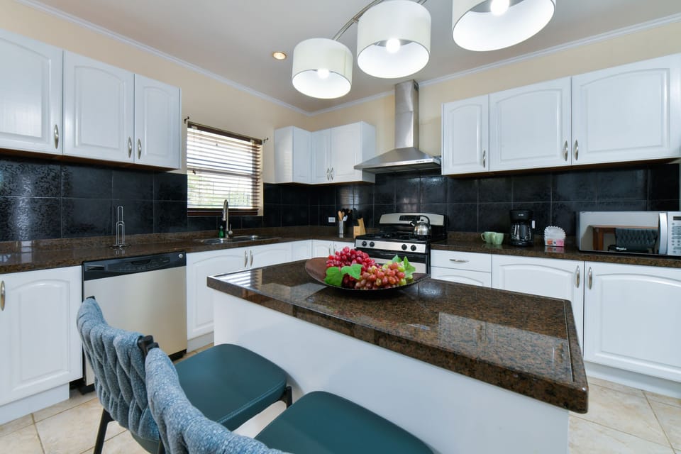 Start your day right: Our kitchen features a cozy breakfast bar, perfect for casual meals and morning gatherings.