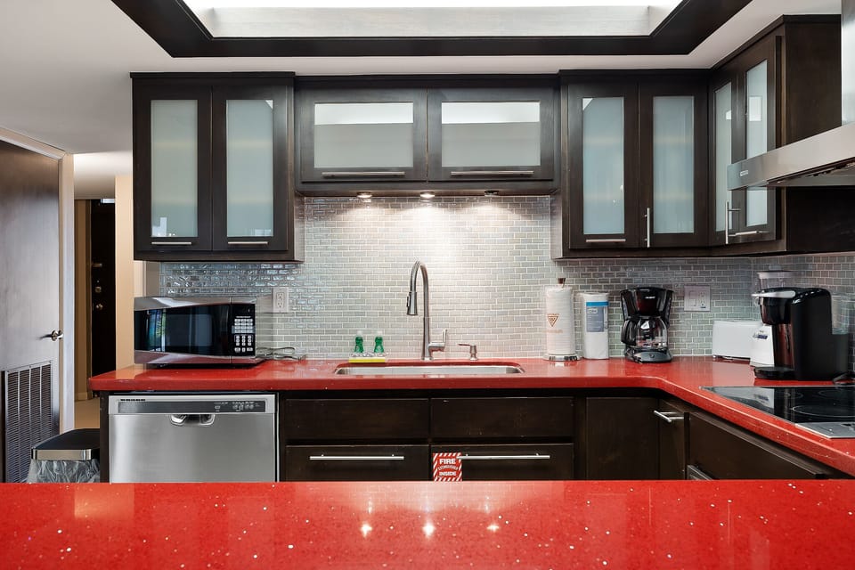 Fully equipped kitchen with coffee maker, cookware, and modern finishes