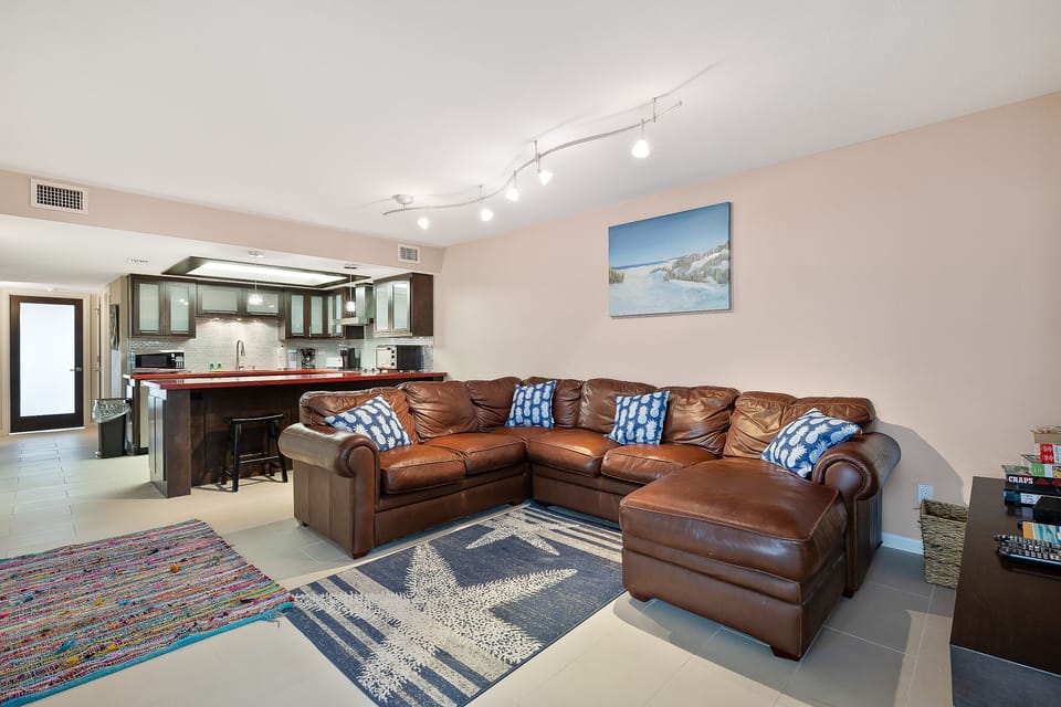 Open-concept living area with oversized sectional and breakfast bar seating