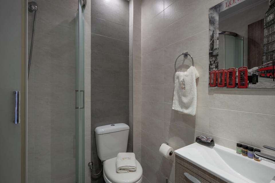 Modern en-suite with a refreshing shower.