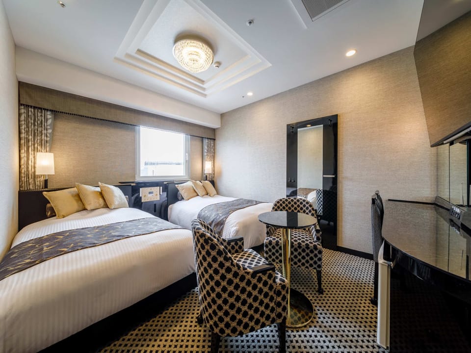 Deluxe Twin Room | Down comforters, desk, laptop workspace, blackout drapes