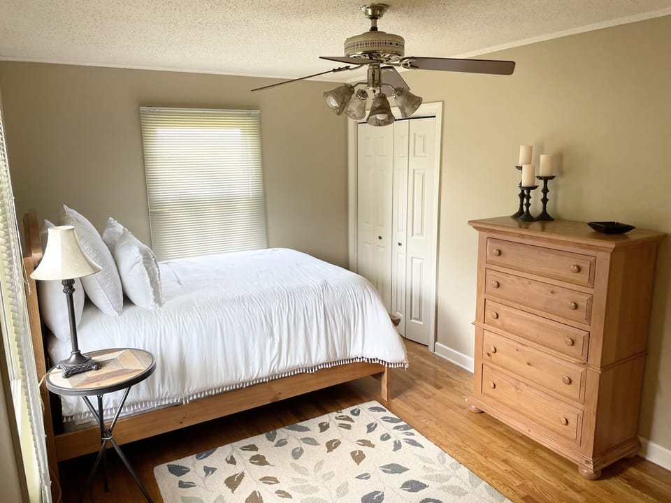 1st bedroom with queen bed, dresser with mirror, chest of drawers and closet.