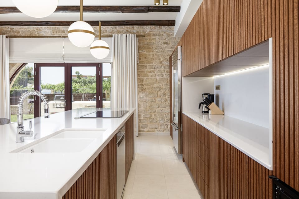 The kitchen offers direct access to the gas BBQ facilities.