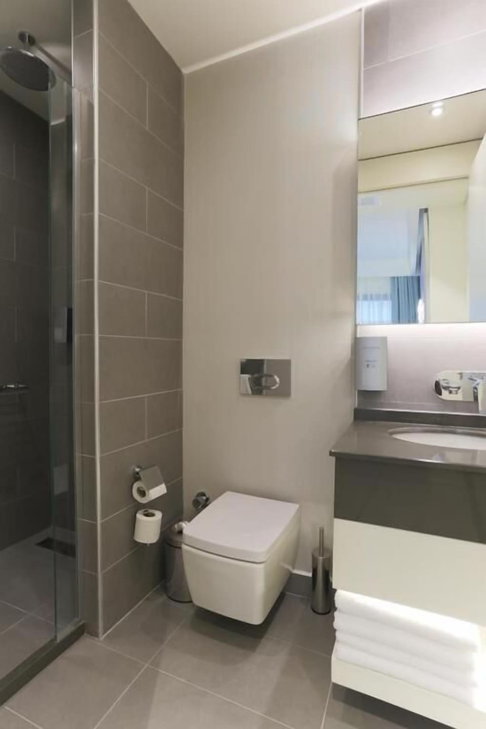 Shower, hair dryer, slippers, towels