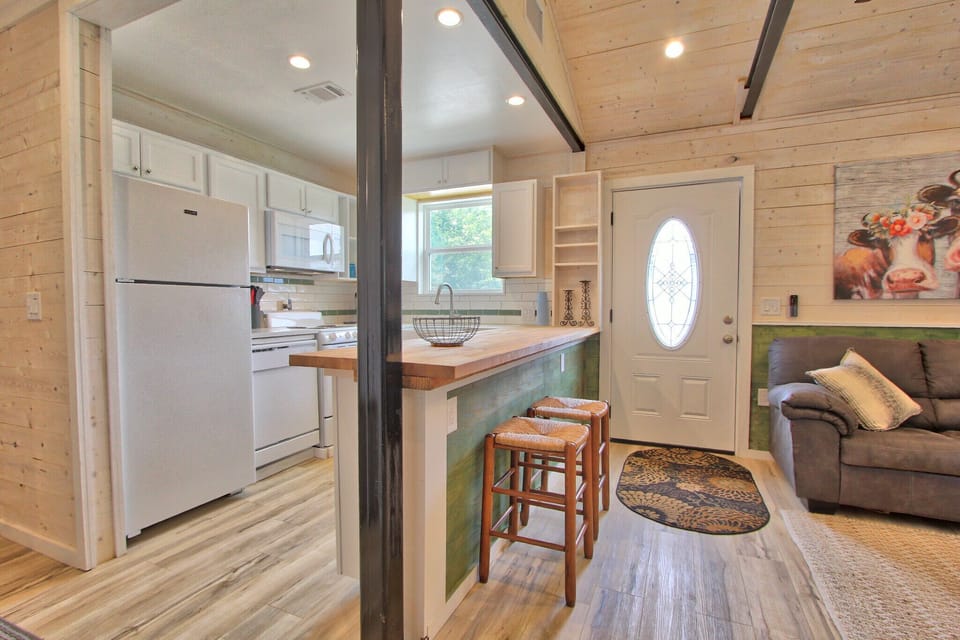 View from bedroom showing the entry door and kitchen.