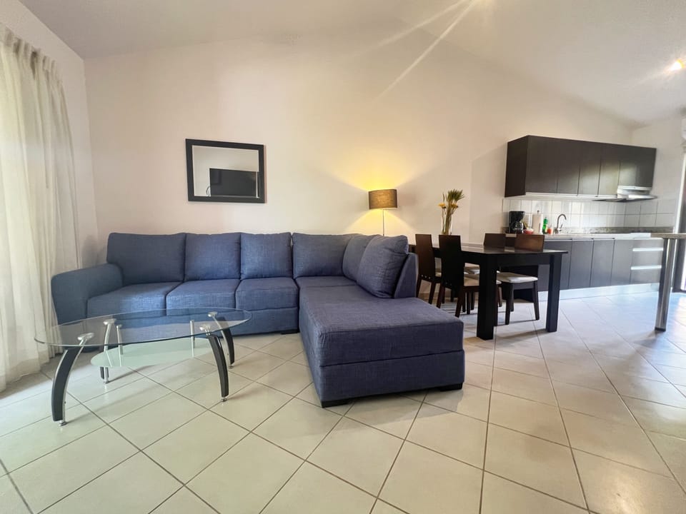 The open concept living/dining/kitchen has a large couch (new in May 2026) and dining for 4.