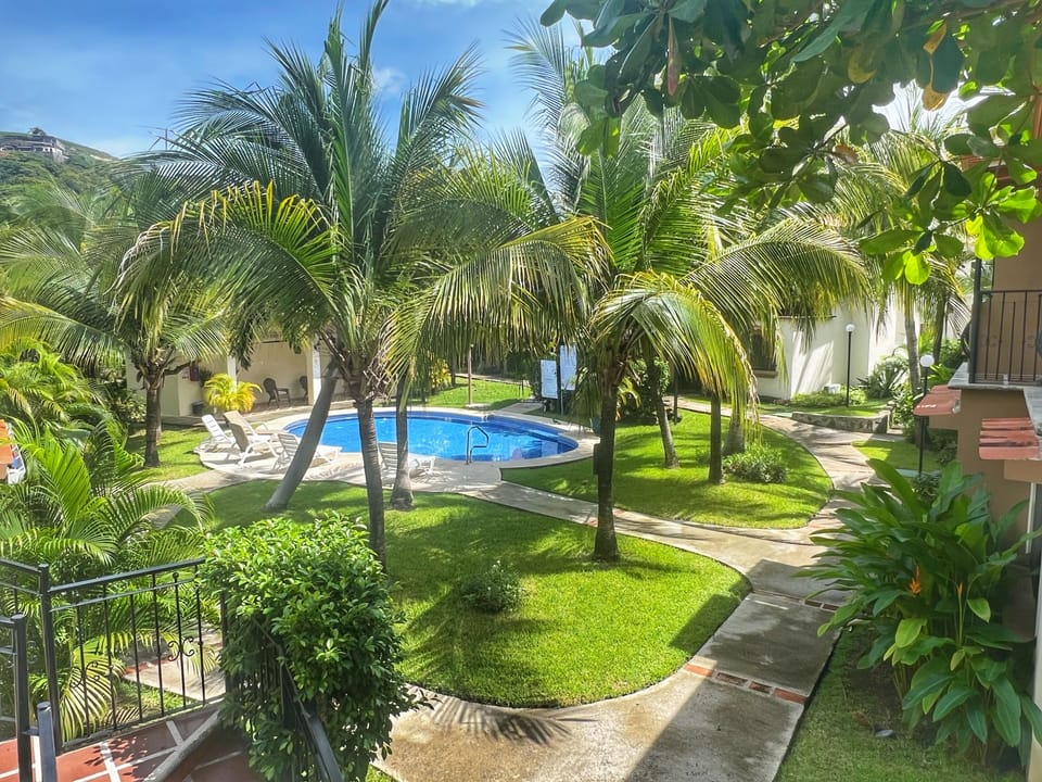 Enjoy beautiful tropical views from your private covered balcony.
