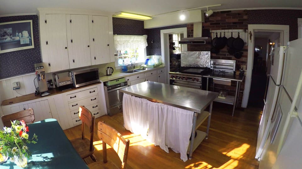 Large Kitchen with  lots of refrigeration, full commercial range and ocean view.
