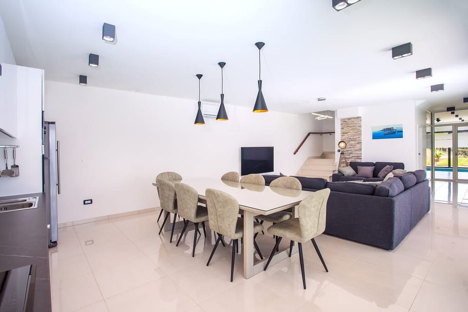 fully equipped kitchen with dinning and living area