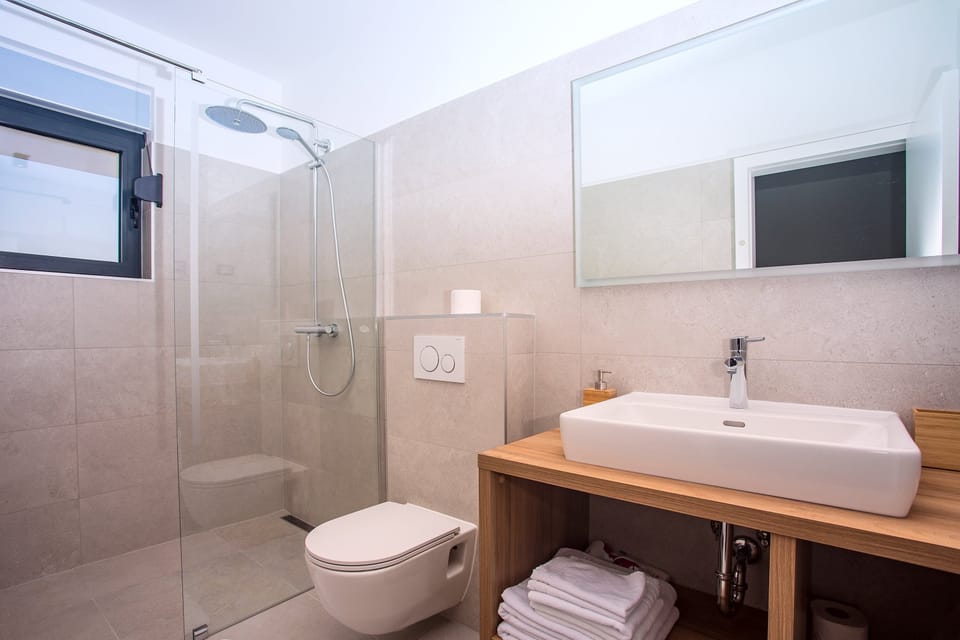 en-suite bathroom with shower and a terrace