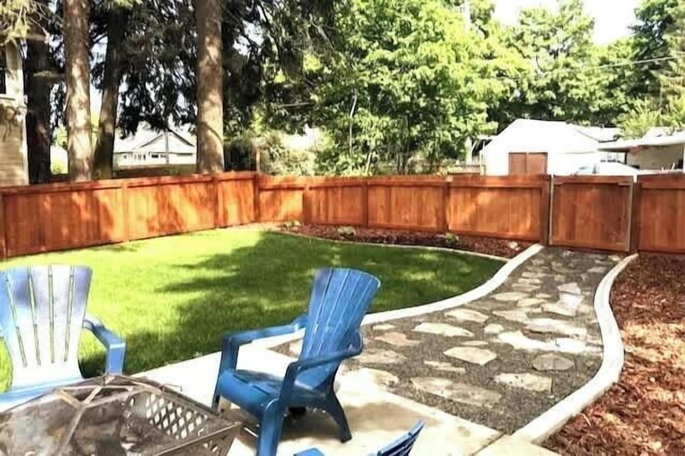 Backyard- Firepit, BBQ, Outside Seating, and Cornhole Boards. 