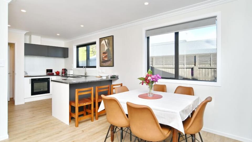 Open-plan kitchen and dining, the heart of the home, with room for everyone around the table.