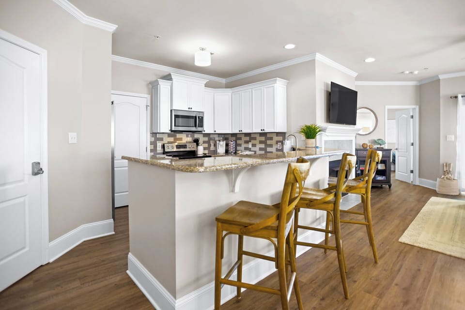 Fully stocked kitchen with seating for 3.