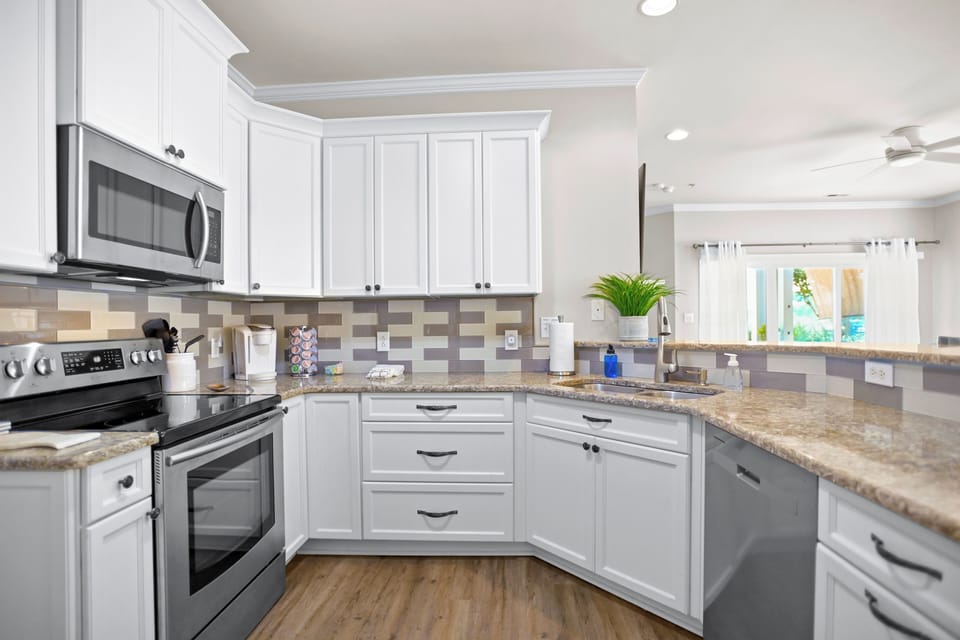 Fully stocked kitchen with seating for 3.