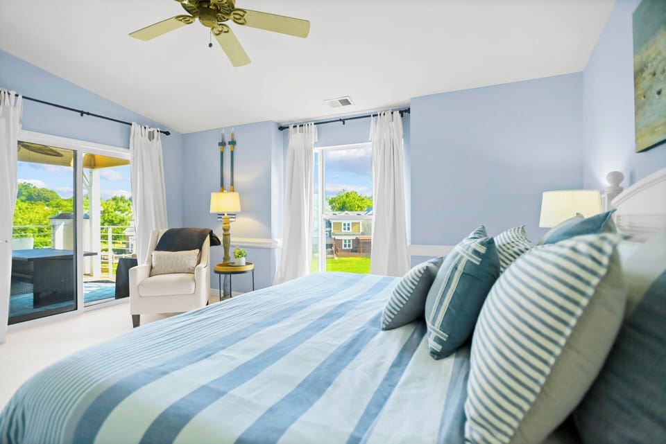 Primary King Suite with deck access and lake views.