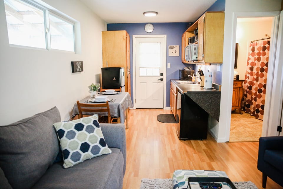 Kitchenette with small oven, 2 refrigerators and eating area. 
